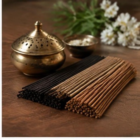 Incense sticks neatly arranged beside a brass holder